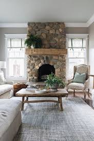 River rocks are usually used in the backyard landscape or in the customization of particular interior items like bars, fireplaces and even indoor swimming pool ensembles. River Rock Fireplace Fireplace Features Natural River Rock Stone And A Chunky Beam Mantel Coz River Rock Fireplaces Living Room Decor Fireplace Home Fireplace