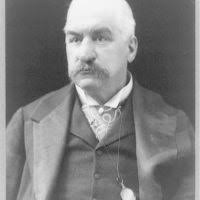 John Pierpont Morgan, Jr., full-length portrait, standing, facing left,  holding U.S. flag]