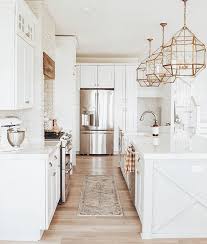 Maybe you would like to learn more about one of these? White Kitchen With Champagne Bronze Fixtures And Brass Lighting Coastal Farmhouse Style Big Kitchen I Kitchen Design Kitchen Inspirations Home Decor Kitchen