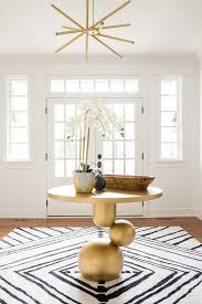 Foyer table are beautiful accessories for adding style to homes, art galleries, or at events. Modern Gold Foyer Table With Black And White Rug Contemporary Entrance Foyer