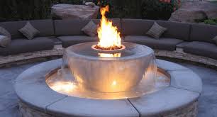 And, for the second (and more showy) idea, a stone basin is filled with water and rigged with gas lines that make it look as if flames are just gliding over the water surface. 10 Pool Fire Pit And Fireplace Designs Your Guests Will Envy