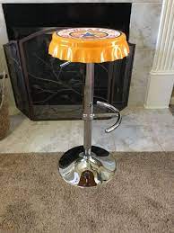 These bottle cap bar stools designed by lumisource add the ultimate touch to any man cave or bachelor pad. Newcastle Brown Ale Bottle Cap Seat Hydraulic Bar Stool Chair Beer Pub Man Cave 1831689409