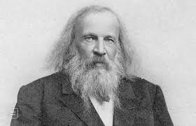 A caricature of dmitri mendeleev standing in front of blocks of elements. 06 March 1869 Mendeleev Presents The Periodic Table Middle And Above Grade 6