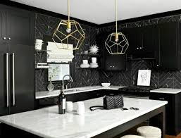 Against the wall are a calacatta marble countertop and a matching backsplash. The Beauty Of Black And White The Scout Guide Shaker Kitchen Cabinets Kitchen Marble White Kitchen Design