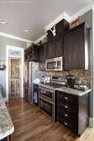 Painting kitchen cabinets is a straightforward diy task that makes a major impact. 10 Black Distressed Cabinets Ideas Distressed Cabinets Black Kitchen Cabinets Rustic Kitchen Cabinets