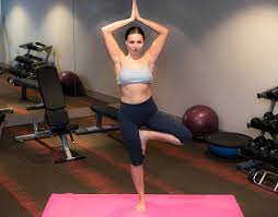 In honor of #nudeweek, the instagram star shows bazaar some of her stunning yoga poses. A Young Woman Smiling While In A Yoga Pose Against A Green Backdrop During The Day By Esther H Photo Stock Snapwire
