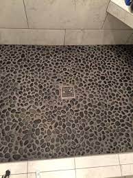 The iridescent black mosaic marble tile adds a touch of drama wherever applied, whether it is used as a kitchen backsplash, shower, floor covering, or countertop application. Glazed Charcoal Black Pebble Tile Pebble Tile Shower Pebble Tile Shower Floor Stone Shower Floor