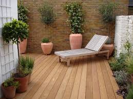 Delineate a different zone by using another flooring, such as decking instead of. Garden Design Decking Small Flowering Trees