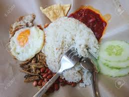 My nasi lemak consists of sambal, fried baby ikan bilis, cucumber slices, roasted peanuts, boiled egg and turmeric chicken. Nasi Lemak Served With Sambal Half Fried Egg Ikan Bilis Fried Stock Photo Picture And Royalty Free Image Image 96515808