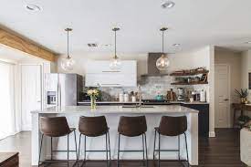 Installing a lighting fixture above the kitchen island creates a great visual point. See How 1 Kitchen Looks With Different Island Lights And Stools