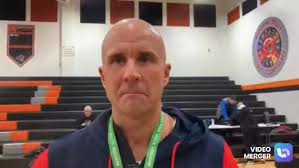 Warren JFK Girls Basketball head coach Marc Morgan along with Gianna  Pompelia following their District Championship win.