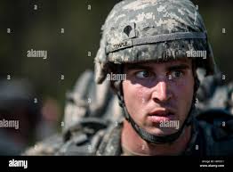 Spc. Andrew Temple, from Owosso, Mich., a human intelligence collector with  the 378th Military Intelligence Battalion, stares off after finishing a  10-kilometer foot march in the North Carolina heat May 5 during