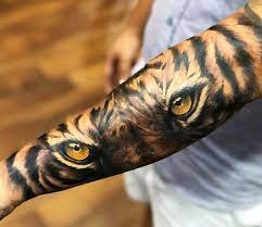 This tiger tattoo allows us to feel that the tiger is peeking over the edge of some obstruction. Tiger Tattoo By Jackson Ayala Post 27957