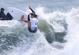 Surfer paddling with surfboard on japanese beach in splash. Knll8bmhp2lgam
