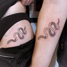 Traditional snake tattoos are the symbol of cultural and traditional traits. Fine Line Matching Snake Tattoo For Couples