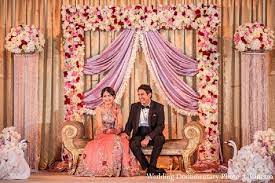 An Indian Bride And Groom At Their Classy Reception Wedding Stage Design Wedding Reception Backdrop Indian Wedding Photography