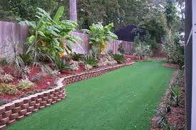 Black stone tiles and privacy walls bring dimension to this tropical garden. Tropical Backyard Landscaping Ideas Home Decor And Interior Design