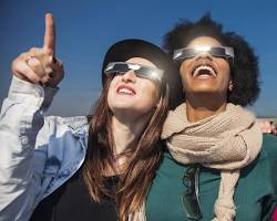 Image of people wearing eclipse glasses