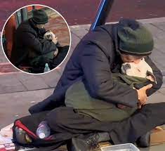 A homeless man in London has captured the attention of thousands, not for  begging, but for the way he rocks his dog to sleep every night. When asked  why, he explained that