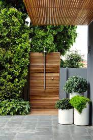 Frosted glass walls close off this outdoor shower space while keeping the space bright. Cool Outdoor Shower Ideas For The Hot Summer Ahead Outdoor Landscape Design Outdoor Landscaping Outdoor Design