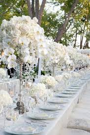 Tall Candle Holders Topped With White Flowers With Gold Pearls Or Beads Handing From The Flowers Wedding Decorations Wedding Centerpieces Wedding