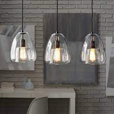 When hanging pendants over a kitchen island, the distance between the bottom of your pendant lights and your countertop should generally be you also want to make sure that your lights aren't blocking your view and that you can see over your counter without them being in your line of sight. Duo Walled 3 Light Pendant Kitchen Lighting Fixtures Kitchen Lighting Kitchen Island Lighting