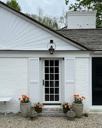 For better or worse, here's the #mudroom door, two years in! 🤍🧡 . . I  didn't plant tulips in my planters last Fall so I was sent scrambling  around earlier this Spring