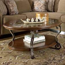 Round tables are easy to move around while square tables pair well with sectionals. Signature Design By Ashley Nestor Oval Cocktail Table Royal Furniture Cocktail Or Coffee Table