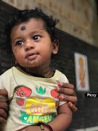 Image Of Indian Baby Boy With Black Curling Hair Posing Nicely And Starring At Someone Sr635926 Picxy