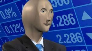 The man is standing before a blue, electronic stock quotation board. 5rimhzrpw4k 5m