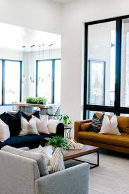 Tell me i'm wrong, but i sure love this entire space! Living Room Interior Design Dark Blue Sofa With White And Navy Pillows Gray Arm Chair Mustard Yello Blue Sofas Living Room Blue Sofa Living Blue Sofa Design