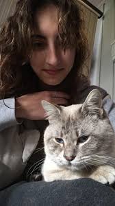 A white and brown siamese cat behind WL McLeod