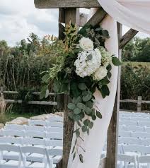 Lighting your outdoor wedding, especially the ceremony space, is extremely important to accentuate this space because you need to create a unique candle lanterns hanging on a birch and flower arch. Backyard And Outdoor Wedding Flower Planning Tips Oasis Floral Products Na