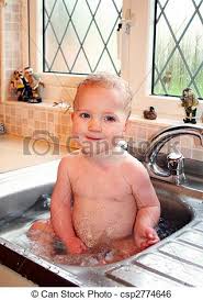child bath in kitchen sink. baby splash