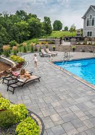 Crisp and smooth paving stones pair great with artificial grass and putting greens. Unilock Paver Pool Deck With Coping Unilock