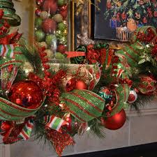 The iconic red carpet is adorned with lush garland and shining baubles that glisten under the warm light. 52 Stunning Christmas Mantels Christmas Fireplace Garland Christmas Garland Christmas Mantel Decorations