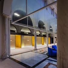 Interior Office Atrium Stone Uplight Linear Pendant Arches Columns Yellow Atrium La Caixa Bank Sev Studio Interior Interior Design Studio Interior