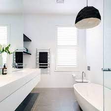 The concrete flooring and exposed wooden ceiling provide amazing textures to this simplistic bathroom. Top 60 Best White Bathroom Ideas Home Interior Designs