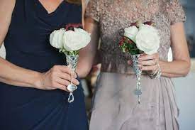 That is why a man leaves his father and mother and clings to his wife, and the two of them become one body. Mothers Of The Bride Groom Carry Pretty Petite Nosegays Comprised Of White Roses Purple Mini Call Mother Of The Bride Bouquets Bride Floral Bride Flowers