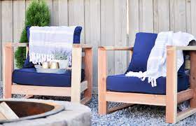 build these comfy modern outdoor chairs using only 2x4 s this chair sits a little low to the ground m modern outdoor chairs outdoor chairs diy patio furniture