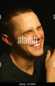 Man in Crunching Grimist Pain Either Emotional or Physical Stock Photo