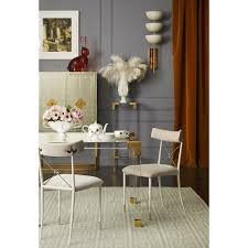 Chunky brass bolts crank up the glam. Jacques Dining Table Jonathan Adler