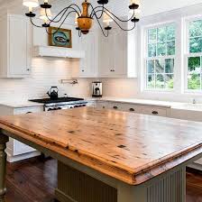 A tiered kitchen island can create clear zones for prep, cleaning, cooking, and dining. Island Counter Tops Whaciendobuenasmigas