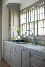 A kitchen featuring baltic brown granite countertops gets an urban feel with black lacquer cabinetry. Light Grey Kitchen Blue Tiles Novocom Top