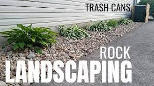 When it comes to landscaping features like fencing and lawn edging, wood is a classic material option. Diy Rock Landscaping Idea River Rock No Fabric Hide Trash Cans Youtube
