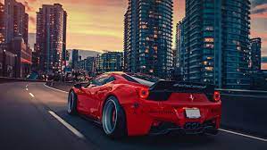 Wallpaper Red Ferrari 458 Italia On Road Near City Buildings During Daytime Background Download Free Image