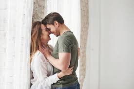 Check spelling or type a new query. Attractive Youth Lovely Couple Kissing And Enjoying Each Other Near The Window Of Their New Home Stock Photo Image Of Flirting Enjoyment 165964762