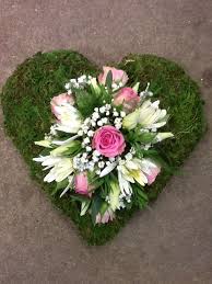 The Moss Heart Makes A Simple Yet Beautiful Base For These Flowers Funeral Flowers Funeral Flowers Flower Arrangements Flowers