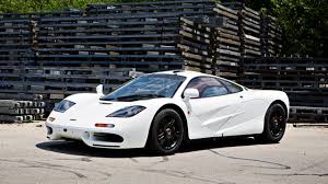 The vehicle is evidently based on the mclaren f1, seen in the overall shape, headlamp panels, side strakes, roof scoop and rear end. Meet The 14m Mclaren F1