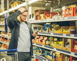 Image of someone looking puzzled in a grocery store